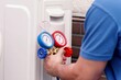 © Andrey Popov - Expert Technician Repairing Air Conditioning Heat Pump