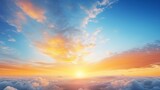 Fototapeta Na sufit - The morning sky at sunrise painted in vibrant yellow and orange hues, contrasting with the serene blue and white clouds, creating a golden summer sky background
