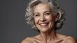 © Amir Bajric - Grey senior woman in t-shirt smiling and looking at camera isolated over white background