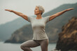 Mature woman doing the warrior pose during yoga