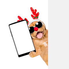 Aufkleber - Happy Mastiff puppy dressed like santa claus reindeer  Rudolf holds big smartphone with empty screen in it paw, showing close to camera behind empty white banner. isolated on white background