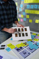 Developer, UI, UX designer, mobile app interface creation process, wireframe On the work desk for mobile app, phone app development plan layout design layout at modern office.