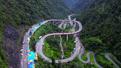 Wall Mural - Aerial 4k video of Kelok 9 bridge at dusk. A popular bridge in Sumatra to commute between cities.