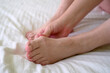 female legs with problem with women's feet, bunion toes in bare feet. Hallus valgus,