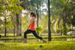© KL 1981 - Asian young women enjoy exercising in the public park. Stretching the body and taking a breath of fresh air. The fresh air helps to feel more energized.