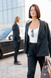 © rh2010 - Businesswoman walks with a handbag on parking lot arrived by luxury car for some event on the evening. Concept of transportation and business lifestyle