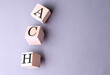 Word ACH Automated Clearing House on wooden block on the grey background