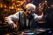 A senior male DJ, with a head of silver hair, dons headphones while playing music at the nighttime venue