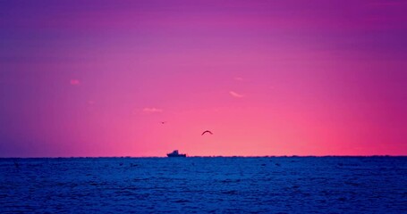 Wall Mural - Color ocean sunrise with sailing fishing boat trawler on the sea horizon 