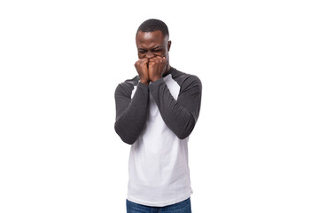 Wall Mural - a young kind American man dressed in a jacket with sleeves is shy on a white background