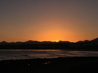 Wall Mural - sunset in lanzarote playa with a reflective sunset on the beach