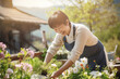 © Irina Bort - Middleaged asian woman working in garden in sunny weather