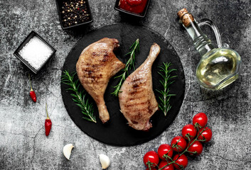 Wall Mural - Grilled duck legs on a stone background