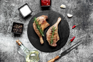 Wall Mural - Grilled duck legs on a stone background