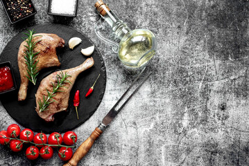 Wall Mural - Grilled duck legs on a stone background with copy space for your text