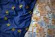 colorful waving national flag of european union on a euro money background. finance concept