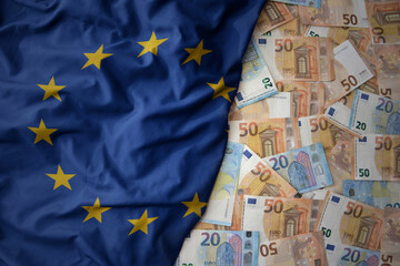 Wall Mural - colorful waving national flag of european union on a euro money background. finance concept