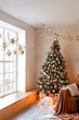 © sergiophoto - Interior of modern living room with comfortable sofa decorated with Christmas tree and gifts