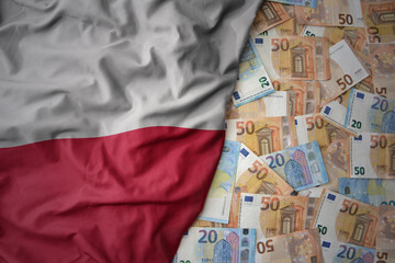 Wall Mural - colorful waving national flag of poland on a euro money background. finance concept