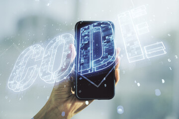 Wall Mural - creative code word sign and hand with mobile phone on background, international software development