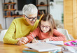 © Lumos sp - grandchild grandmother family granddaughter child teacher homework creativity home woman book notebook grandma education classroom grandparent parent daughter girl kid teaching