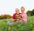 © Lumos sp - woman man outdoor senior couple happy lifestyle retirement together smiling love reading nature book