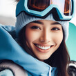 Portrait of snowboarder smiling happy young woman in blue suit goggles mask, hat, ski padded jacket. ai generative