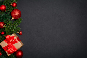 Wall Mural - Christmas decorations and gift box on black background with copy space. Christmas background