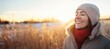 Backlit Portrait of calm happy smiling free woman with closed eyes enjoys a beautiful moment life on the fields in winter time with snow at sunset or dawn