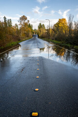 Wall Mural - After the storm, rainwater flooding over a residential street on a sunny fall day
