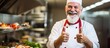 © AkuAku - The chef with a content expression gazes confidently at the camera displaying a gesture of approval while laughing