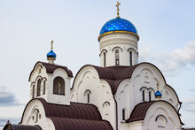 View Of A Stone Orthodox Church With Blue Domes And Gilded Crosses. Village Krivskoye, Kaluga Region, Russia