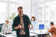 © BullRun - Happy man showing thumbs up during conference in office