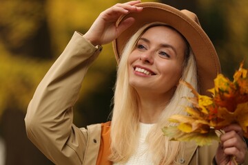 Sticker - Portrait of happy woman with autumn leaves outdoors