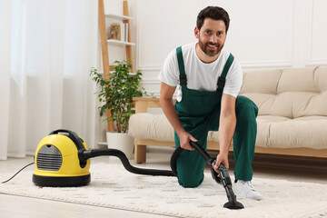 Poster - Dry cleaner's employee hoovering carpet with vacuum cleaner in room