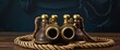 Vintage Binoculars on a nautical rope background, offset to top left, room for text. Collectable object finished in leather and brass.