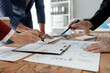 © Chadaporn - Group of businessmen working together to calculate income, They are revising the financial numbers, Take out financial documents and check them with a calculator,