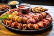 An assortment of bacon wrapped appetizers on a platter