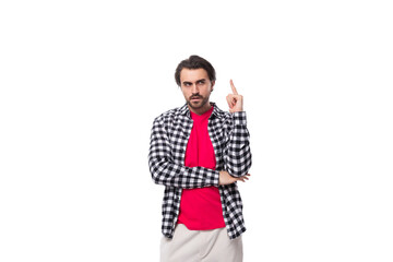 Wall Mural - portrait of a young handsome brunette caucasian man with a beard dressed in a plaid shirt on a white background