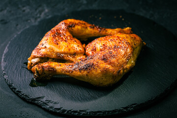 Wall Mural - BBQ grilled chicken legs on black background