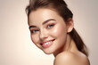 Skin care. Woman with beauty face touching healthy facial skin portrait. Beautiful smiling girl model with natural makeup touching glowing hydrated skin on light background closeup.