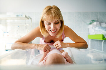 Poster - Portrait of beautiful mother with her newborn baby.