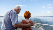 Grandfather And Grandson Looking At Sea From Ship