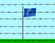 European Union Flag Behind Barbed Wire Under Sky
