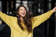 © Westend61 - Cheerful woman with arms outstretched on sunny day
