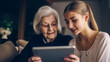 © EUGINE - A grandmother relives memories with her granddaughter by viewing images and videos of family members and loved ones through a tablet.