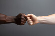 © Ivan - Fists of African beauty and Caucasian man touching on isolated gray background, friendship concept.generative ai