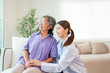 © kelvn - Asian female doctor taking care and talking mature female patient sitting on sofa in hospital. Healthcare concept.
