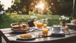Summer outdoor breakfast table on patio. There is pancake, egg, orange juice, coffee, tea etc.