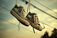 Pair Of Shoes That Hanging On The Telephone Wire Outdoors, Focused View, Daytime